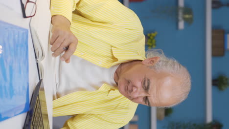 Vertical-video-of-Home-office-worker-old-man-happy-and-cheerful.