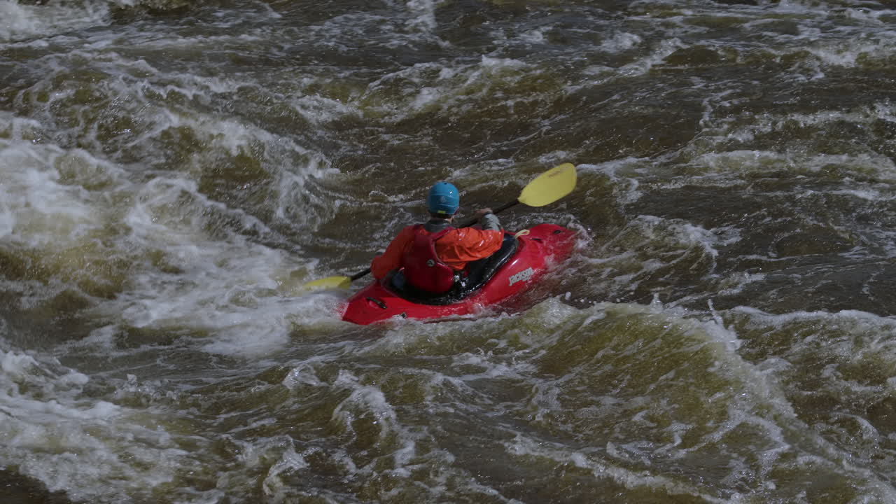 Kayak sportivo al rallentatore nelle rapide.