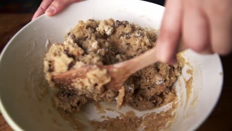 slow motion closeup of mixing chocolate cookie dough in bowl