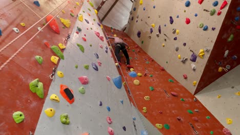 low angle of coach assisting woman in bouldering 4k