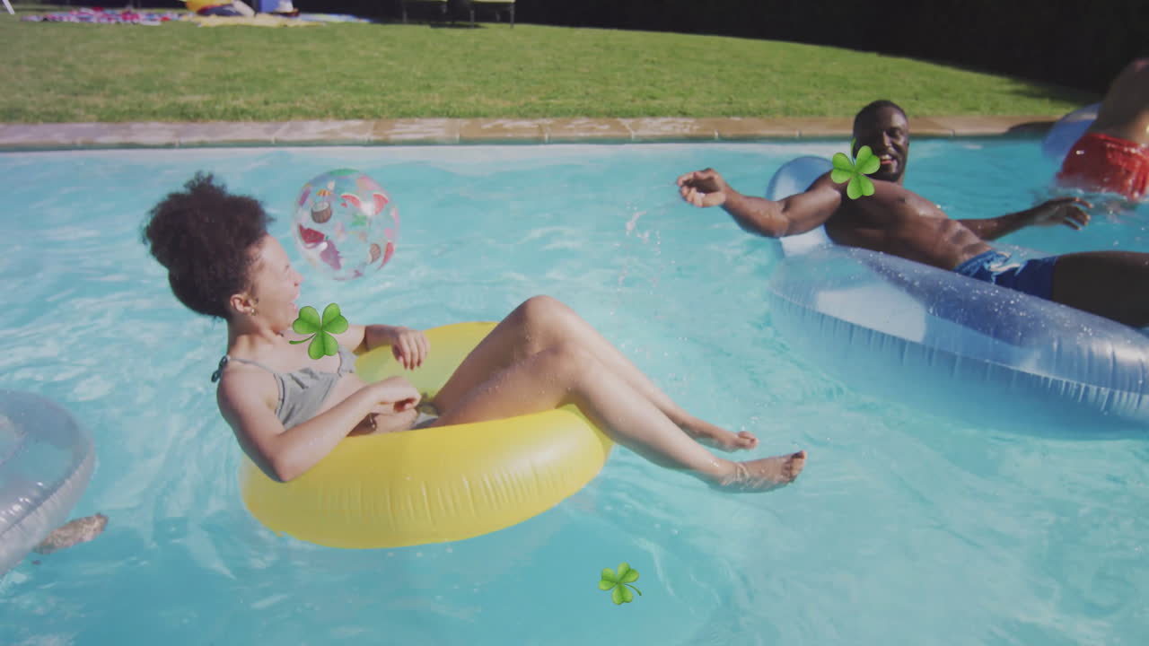 People relaxing on pool floats with clover animations in sunny backyard pool