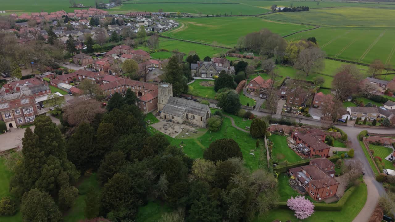 Smuk droneudsigt over historisk Church of England-bygning i Yorkshires landskab i landsbyen Goldsborough i North Yorkshire på en overskyet dag.