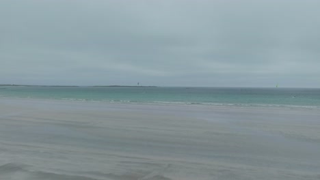 a lonely kitesurfer in a bay on the isle of tiree