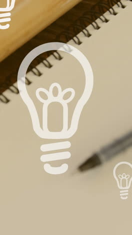 animation of lightbulb icons over notebook and pen