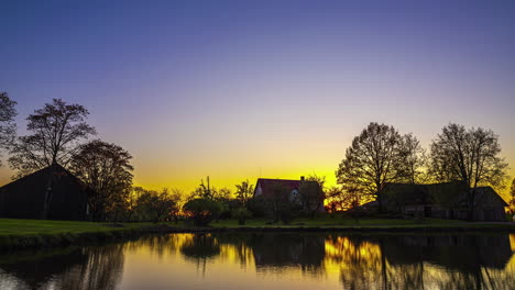 stunning transition from day to night in time-lapse over a serene lake house with aurora borealis