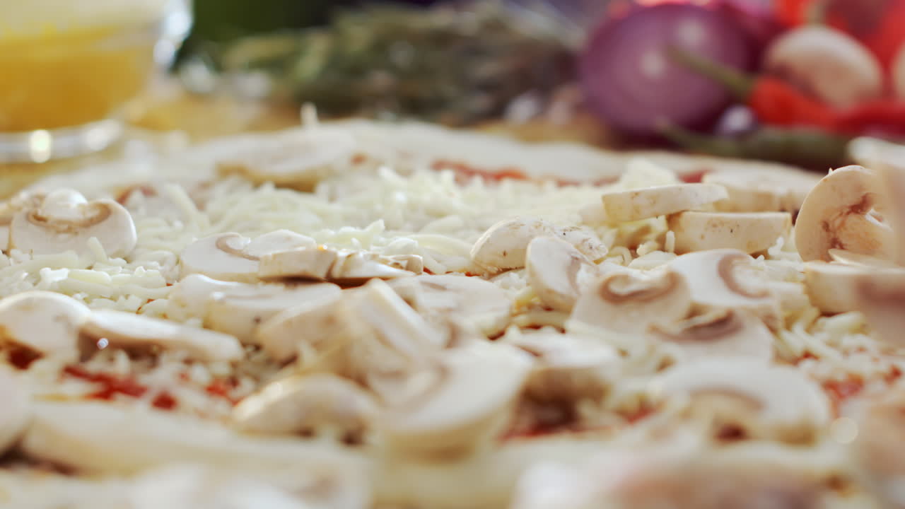 Pizza preparation with mushrooms and cheese