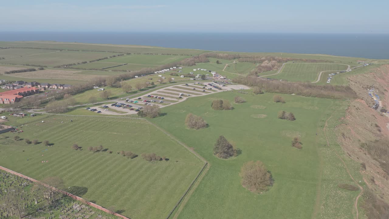 Cliff top farmland near Ravine Road Filey North Yorkshire England with arable fields and improved pasture typical of cereal and grass rotation on chalk and glacial soils above North Sea coast, aerial