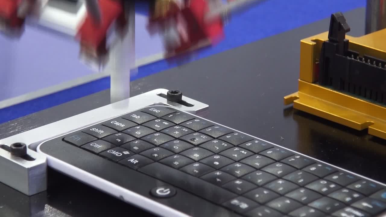 Close up of a robot typing on a keyboard