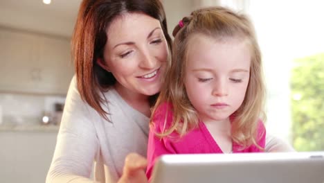 Mother-and-daughter-using-tablet-pc