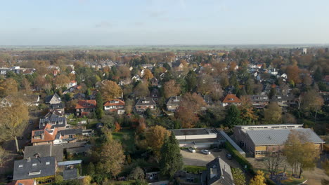 Jib-down-of-suburban-neighborhood-with-children-playing-on-a-school-square