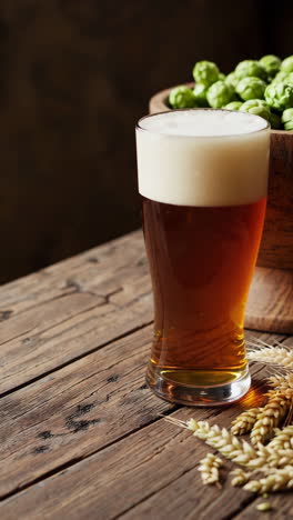 a glass of beer and hops