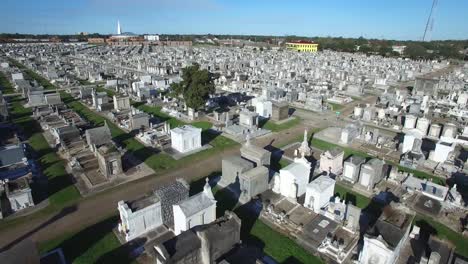 haunting low aerial shot over a new orleans cemetery with raised gravestones 1