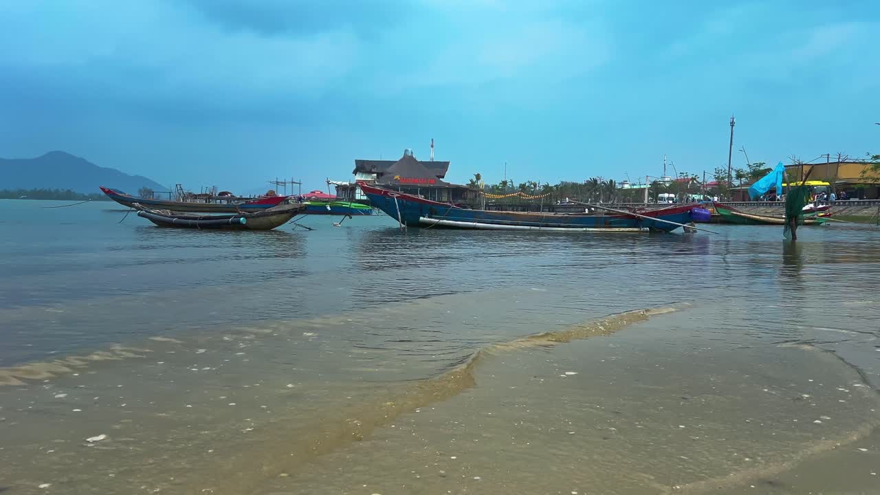 Traditional Wooden Boats Anchored Near Shoreline. Static Shot