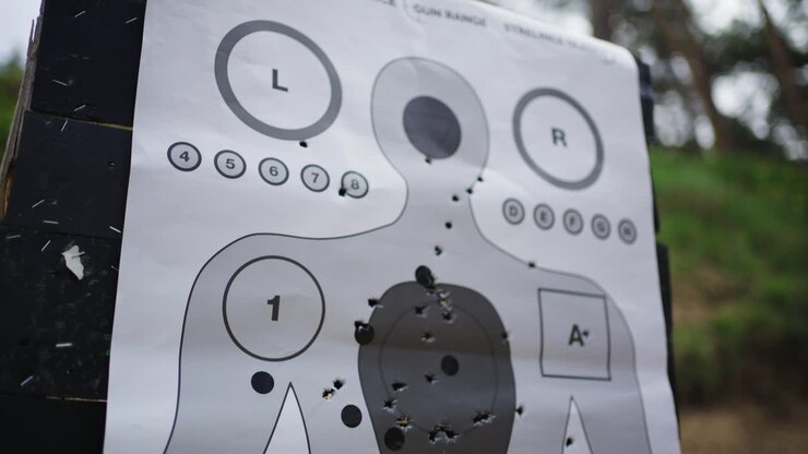 Human silhouette paper target with bullet holes at Olesko shooting range