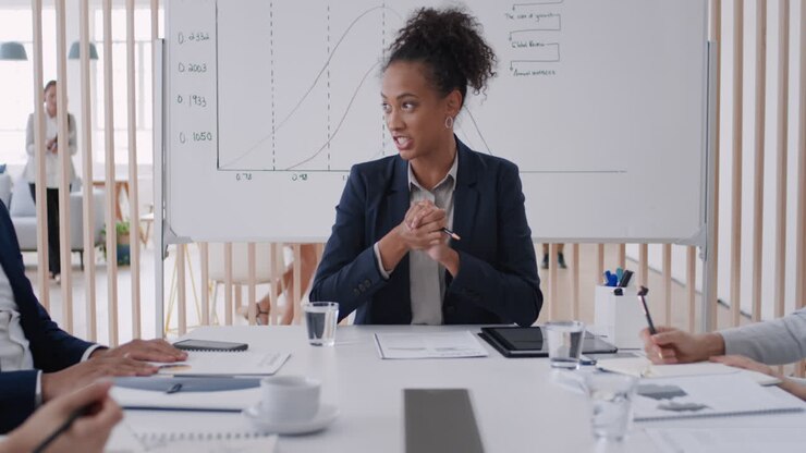 professional business woman team leader meeting with colleagues sharing creative ideas for startup project discussing corporate strategy in office boardroom