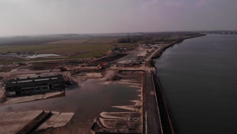 Aerial-view-of-a-building-site-with-excavators-in-the-countryside,-Puttershoek