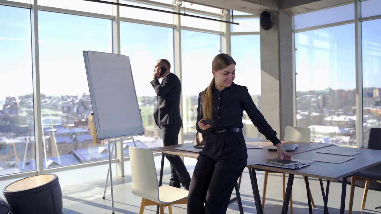 Business colleagues work in office room. Entrepreneur man in suit talking the phone. Beautiful female secretary standing in office.
