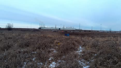 Smokestacks-working-amidst-an-open-field