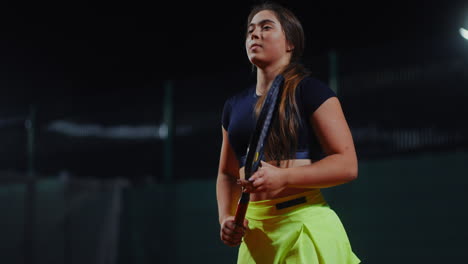 female tennis player at night