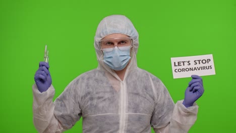 Doctor-in-PPE-suit-with-syringe,-ampoule-and-text-slogan-on-paper-Lets-Stop-Coronavirus,-chroma-key