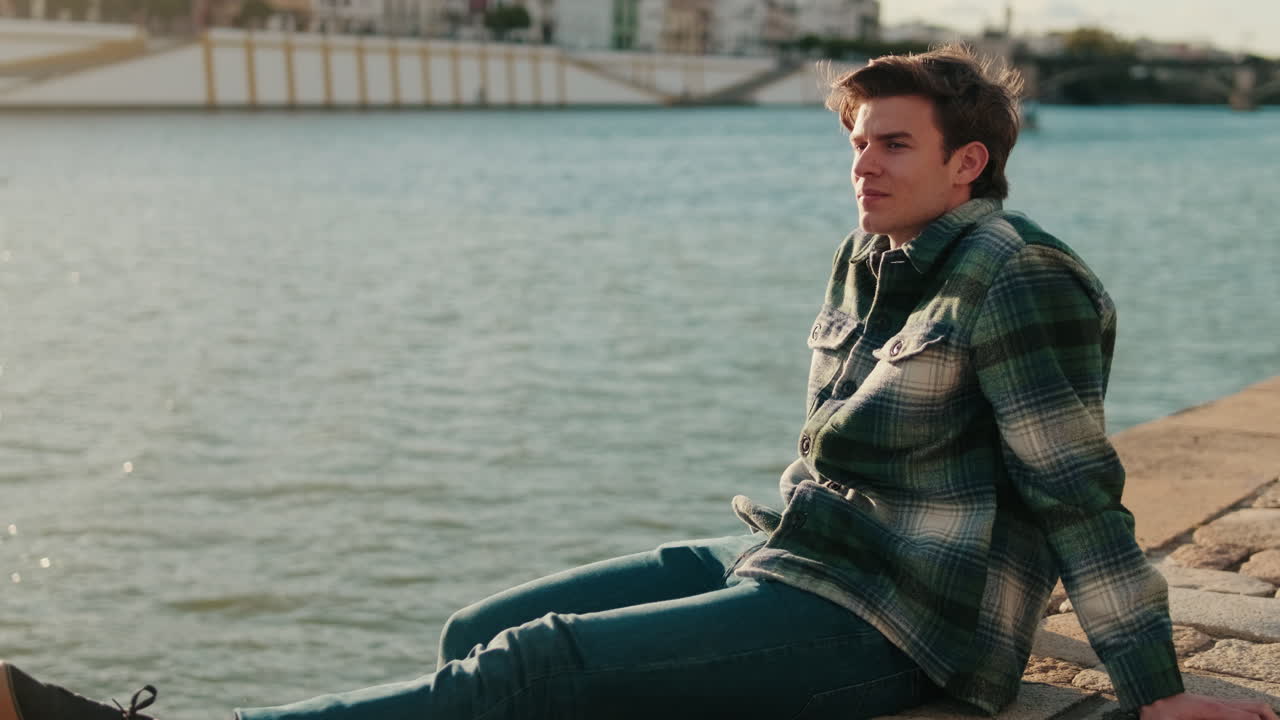 Young Man Enjoying Seville Sunset By The River
