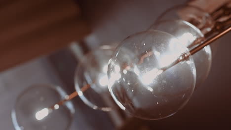 Stylish-chandelier-with-glass-balls-and-glowing-lamps