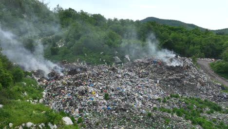 aerial view of a garbage dump that is burning in places