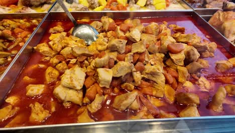 chicken and vegetable stew in a restaurant tray