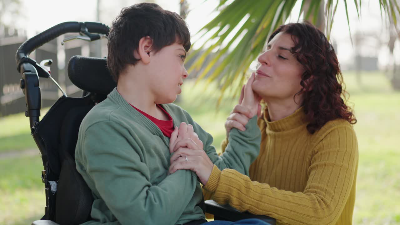 Woman and child in wheelchair sharing a moment