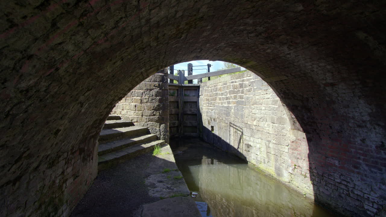 Shot under the arch of a humpback bridge over the Chesterfield Canal at Stret lock with lock in background