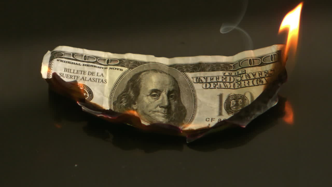 Hundred dollar bill burning