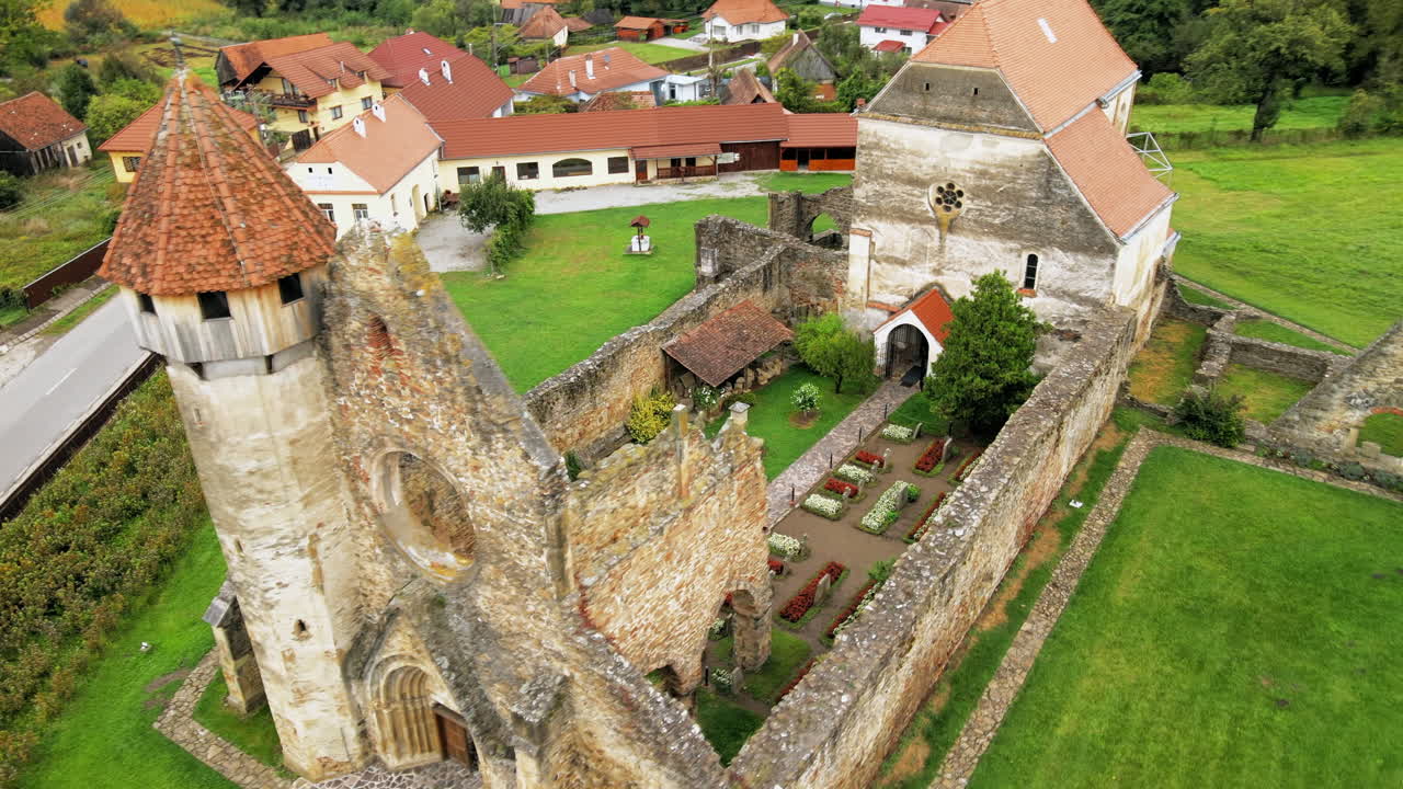 Aerial drone view of the ruins of medieval Cistercian abbey in Romania. Carta Monastery, medieval buidlings, greenery