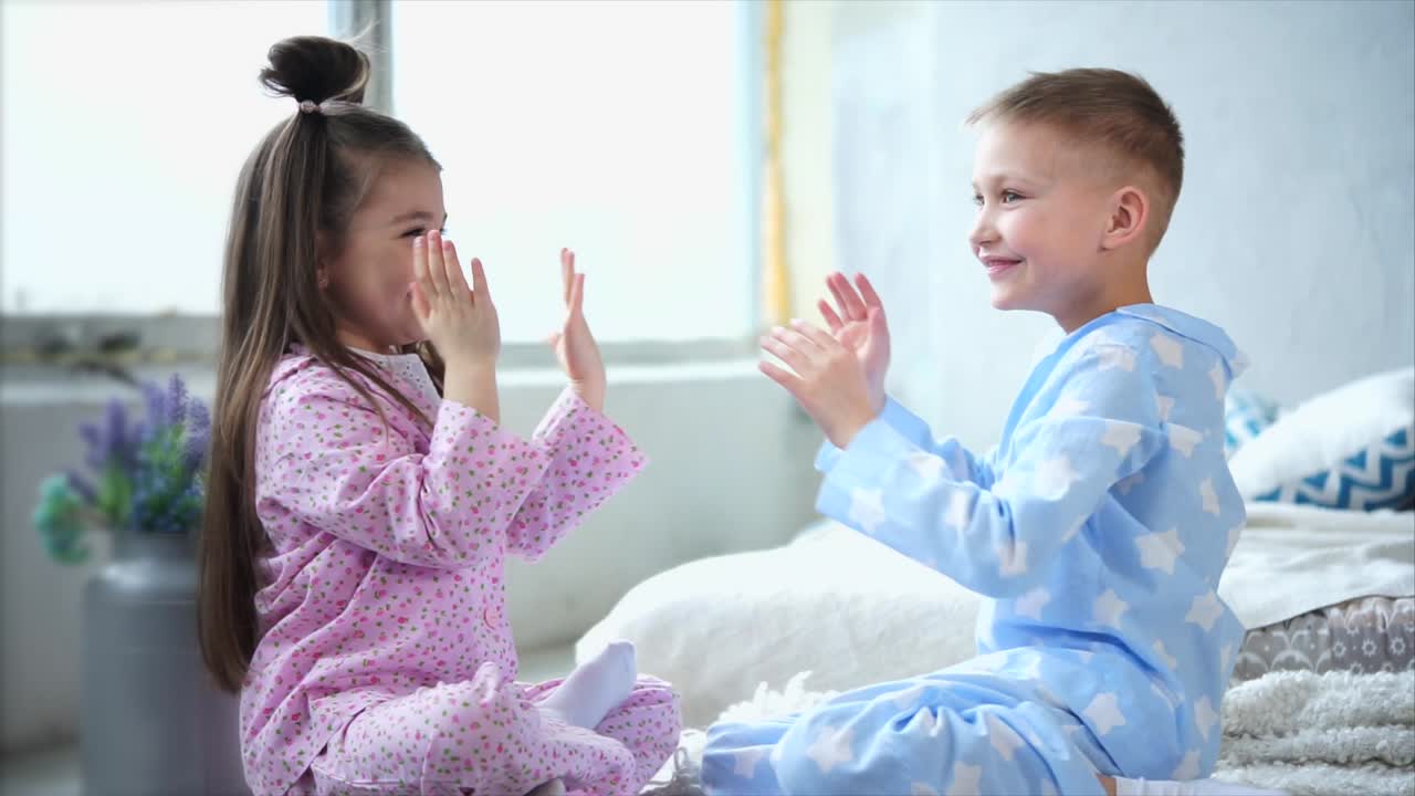 Happy Siblings Playing in Pajamas