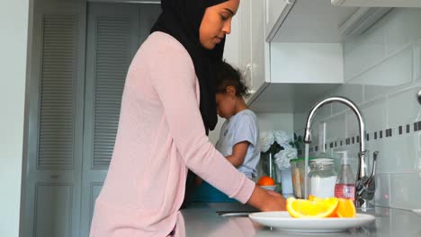 young mother washing dishes in kitchen at home 4k