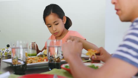 Family-members-having-breakfast-on-dining-table-4k