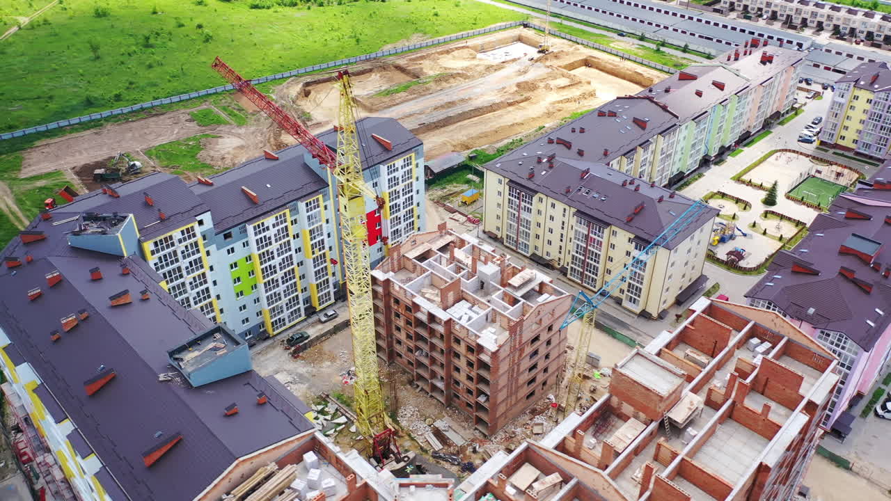 Construction site of a modern district in the city. Colorful urban buildings in a new microdistrict. Building with a bird's eyes.