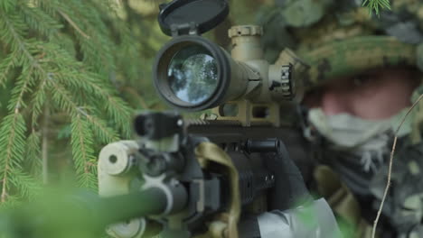 soldier sitting with rifle in ambush