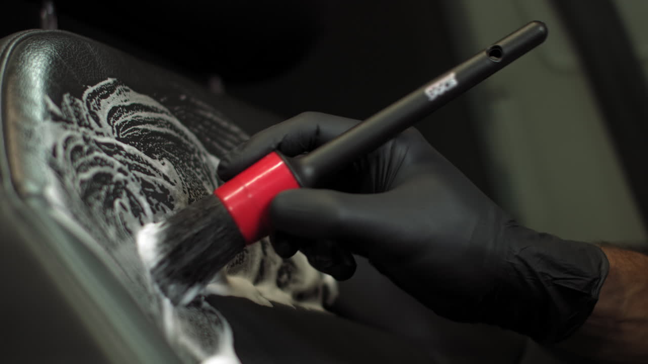 Cleaning Car Seats with Foam and Brush