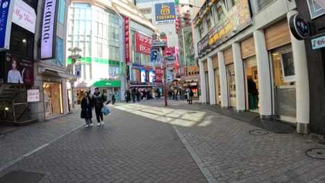 pedestrians walking through a busy city district