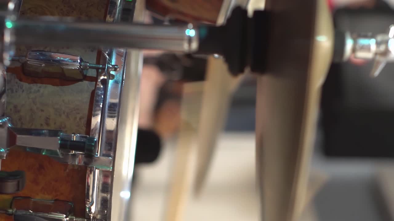 Person playing a drum kit, cymbals and bass drum