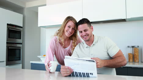 Happy-couple-smiling-at-the-camera-in-the-morning