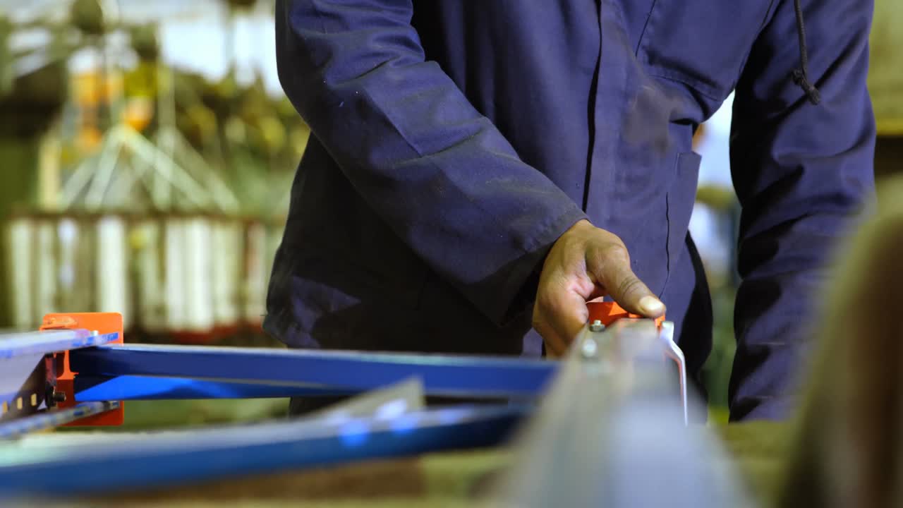 Operaio che ripara una macchina per la produzione di corde 4k