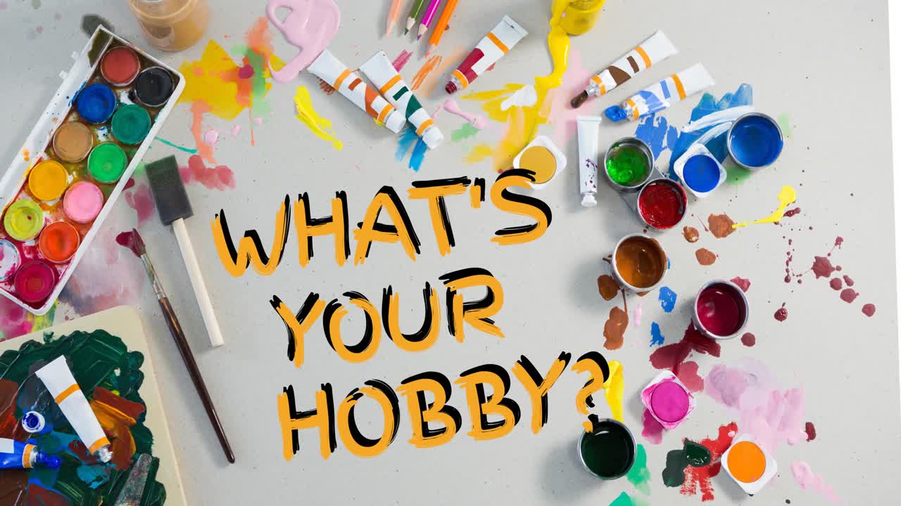 Animation of what's your hobby text in yellow, over watercolour paints and paintbrushes on table top