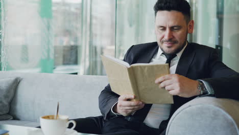 businessman reading in a cafe