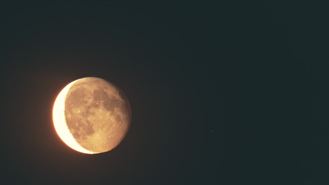 The shaded moon in the clear night sky