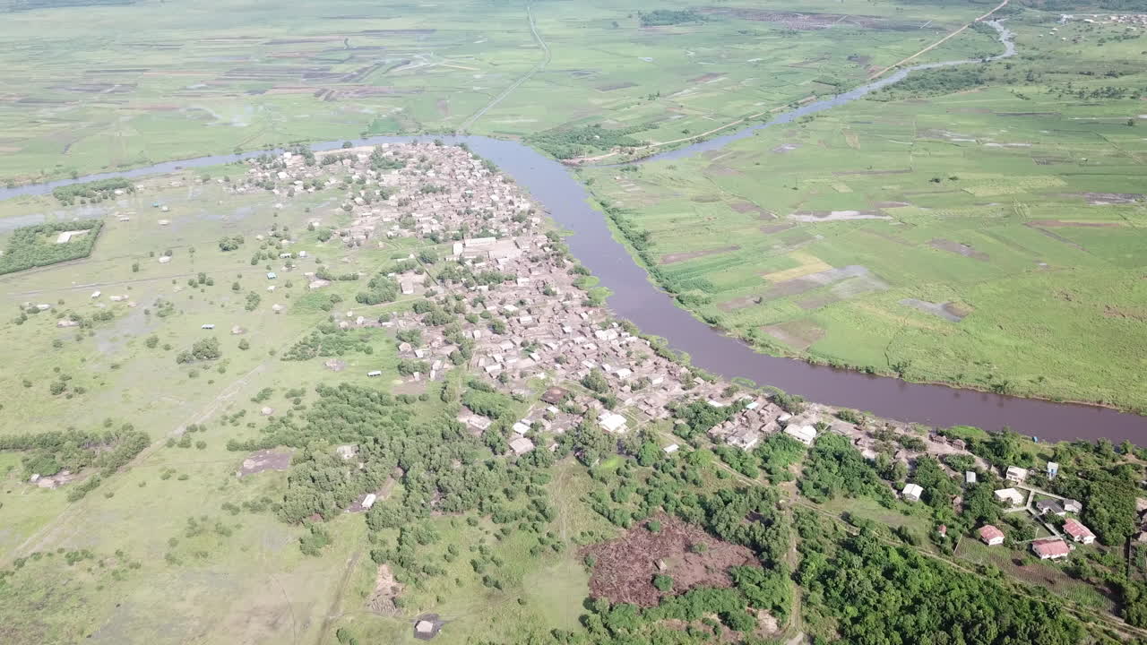Wide shot of village along Oueme River in Benin
