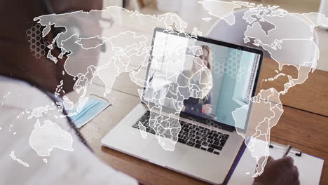world map animation over person video conferencing on laptop at home