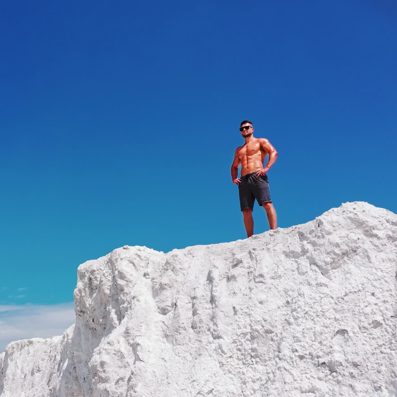 Sportsman standing on cliff of mountain