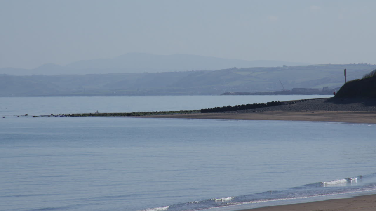 shot of the beach looking east over new quay Bay