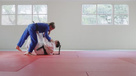 judokas fighting and immobilizing on the ground